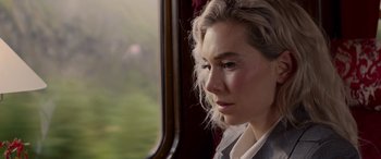 Movie still from “Mission: Impossible - Dead Reckoning Part One” (2023), directed by Christopher McQuarrie – A woman looking out of a window on a train; Close Up shot, Low angle