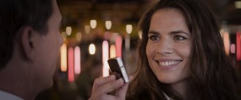 Movie still from “Mission: Impossible - Dead Reckoning Part One” (2023), directed by Christopher McQuarrie – A woman holding a cell phone in her hand; Close Up shot, Over the shoulder angle