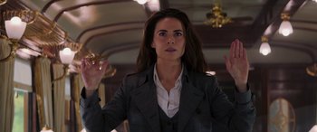 Movie still from “Mission: Impossible - Dead Reckoning Part One” (2023), directed by Christopher McQuarrie – A woman in a gray jacket holding a cigarette; Medium shot, Low angle