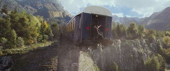 Movie still from “Mission: Impossible - Dead Reckoning Part One” (2023), directed by Christopher McQuarrie – A train traveling over a bridge on a cliff; Wide shot, Low angle