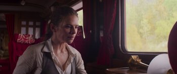 Movie still from “Mission: Impossible - Dead Reckoning Part One” (2023), directed by Christopher McQuarrie – A woman sitting on a train looking out the window; Close Up shot, Low angle