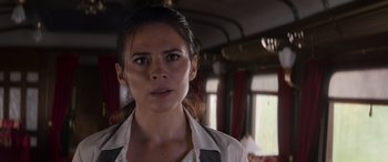Movie still from “Mission: Impossible - Dead Reckoning Part One” (2023), directed by Christopher McQuarrie – A person in a train car; Close Up shot, Over the shoulder angle