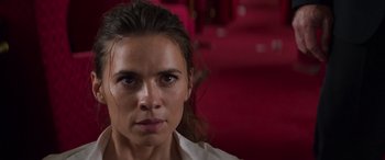 Movie still from “Mission: Impossible - Dead Reckoning Part One” (2023), directed by Christopher McQuarrie – A person wearing a white shirt; Close Up shot, Over the shoulder angle