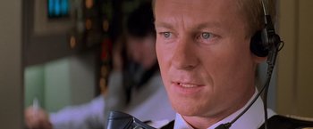 Movie still from “Mission: Impossible II” (2000), directed by John Woo – A person wearing a suit and tie; Close Up shot, Over the shoulder angle