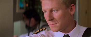 Movie still from “Mission: Impossible II” (2000), directed by John Woo – A person wearing a uniform; Close Up shot, Low angle