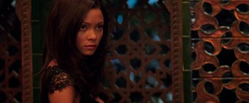 Movie still from “Mission: Impossible II” (2000), directed by John Woo – A beautiful young lady posing for a picture; Close Up shot, High angle