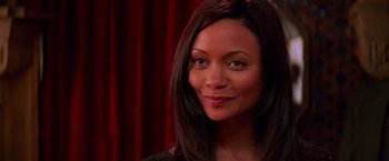 Movie still from “Mission: Impossible II” (2000), directed by John Woo – A person with long black hair; Close Up shot, Over the shoulder angle