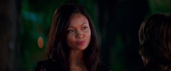 Movie still from “Mission: Impossible II” (2000), directed by John Woo – A person with long black hair; Close Up shot, Over the shoulder angle