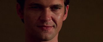 Movie still from “Mission: Impossible II” (2000), directed by John Woo – A man's face in a dark room; Extreme Close Up shot, Low angle