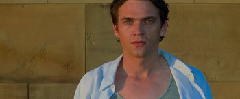 Movie still from “Mission: Impossible II” (2000), directed by John Woo – A person wearing a blue shirt; Close Up shot, Low angle