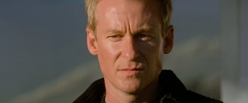 Movie still from “Mission: Impossible II” (2000), directed by John Woo – A man with blonde hair; Close Up shot, Low angle