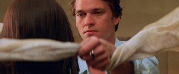 Movie still from “Mission: Impossible II” (2000), directed by John Woo – A person holding a rope; Close Up shot, Over the shoulder angle