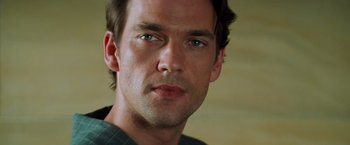 Movie still from “Mission: Impossible II” (2000), directed by John Woo – A man's face with green eyes; Close Up shot, Low angle