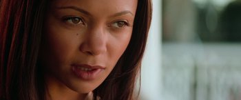 Movie still from “Mission: Impossible II” (2000), directed by John Woo – A woman's face with green eyes; Close Up shot, Over the shoulder angle