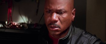 Movie still from “Mission: Impossible II” (2000), directed by John Woo – A person wearing a black jacket; Close Up shot, Low angle