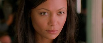 Movie still from “Mission: Impossible II” (2000), directed by John Woo – A woman's face with green eyes; Close Up shot, High angle