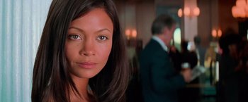 Movie still from “Mission: Impossible II” (2000), directed by John Woo – A woman's face in front of a man; Close Up shot, Low angle