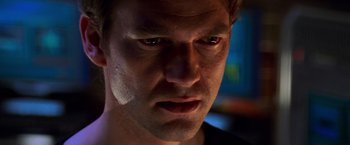 Movie still from “Mission: Impossible II” (2000), directed by John Woo – A man's face in the dark; Close Up shot, Low angle