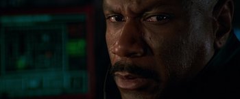 Movie still from “Mission: Impossible II” (2000), directed by John Woo – A man's face in a dark room; Extreme Close Up shot, High angle