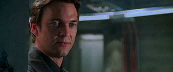 Movie still from “Mission: Impossible II” (2000), directed by John Woo – A person wearing a suit and tie; Close Up shot, Low angle