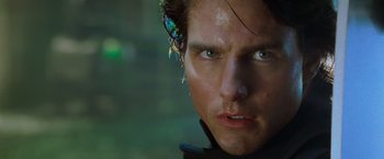 Movie still from “Mission: Impossible II” (2000), directed by John Woo – A man's face with a bug on his ear; Close Up shot, Low angle