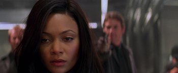 Movie still from “Mission: Impossible II” (2000), directed by John Woo – A woman and a man are standing in a room; Close Up shot, Over the shoulder angle