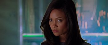 Movie still from “Mission: Impossible II” (2000), directed by John Woo – A person with long black hair; Close Up shot, Over the shoulder angle