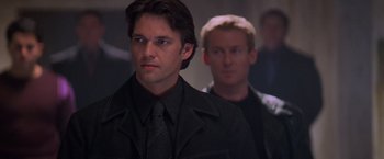 Movie still from “Mission: Impossible II” (2000), directed by John Woo – A man in a black jacket and a man in a black jacket; Close Up shot, Low angle