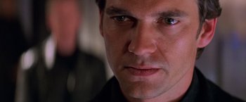 Movie still from “Mission: Impossible II” (2000), directed by John Woo – A man's face looking at the camera; Close Up shot, Over the shoulder angle