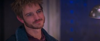 Movie still from “Mission: Impossible II” (2000), directed by John Woo – A person with a beard; Close Up shot, Over the shoulder angle