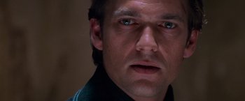 Movie still from “Mission: Impossible II” (2000), directed by John Woo – A man's face with blue eyes; Close Up shot, Over the shoulder angle