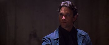 Movie still from “Mission: Impossible II” (2000), directed by John Woo – A person wearing a suit and tie; Close Up shot, Low angle