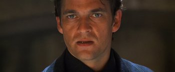 Movie still from “Mission: Impossible II” (2000), directed by John Woo – A man's face with blue eyes; Close Up shot, Low angle