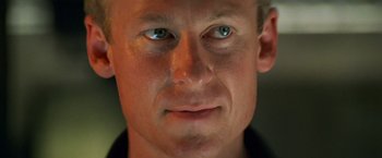 Movie still from “Mission: Impossible II” (2000), directed by John Woo – A man's face with blue eyes; Close Up shot, Low angle