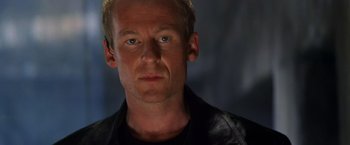 Movie still from “Mission: Impossible II” (2000), directed by John Woo – A person wearing a black jacket; Close Up shot, Low angle