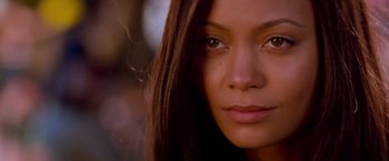 Movie still from “Mission: Impossible II” (2000), directed by John Woo – A woman's face with long brown hair; Close Up shot, Over the shoulder angle