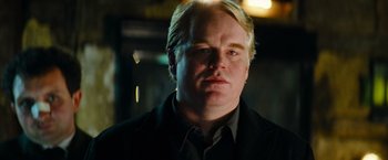 Movie still from “Mission: Impossible III” (2006), directed by J.J. Abrams – A person wearing a suit and tie; Close Up shot, Low angle