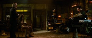 Movie still from “Mission: Impossible III” (2006), directed by J.J. Abrams – A room with a chair and a desk in it; Wide shot, Over the shoulder angle