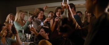Movie still from “Mission: Impossible III” (2006), directed by J.J. Abrams – A group of people holding wine glasses and toasting; Medium shot, Over the shoulder angle