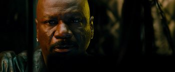 Movie still from “Mission: Impossible III” (2006), directed by J.J. Abrams – A person's face in a dark room; Close Up shot, Low angle