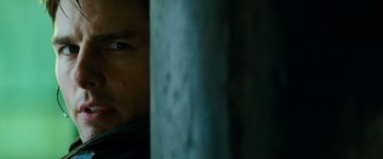 Movie still from “Mission: Impossible III” (2006), directed by J.J. Abrams – A man's face behind a blue pole; Close Up shot, Over the shoulder angle