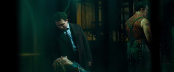 Movie still from “Mission: Impossible III” (2006), directed by J.J. Abrams – A man standing next to a woman in a dark room; Medium shot, High angle