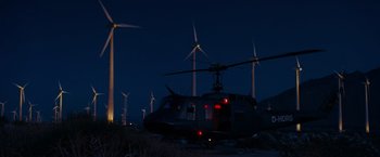 Movie still from “Mission: Impossible III” (2006), directed by J.J. Abrams – A helicopter parked in front of some windmills at night; Extreme Wide shot, Low angle