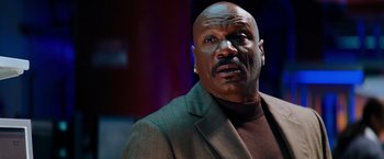 Movie still from “Mission: Impossible III” (2006), directed by J.J. Abrams – An older man in a suit looking at the camera; Close Up shot, Low angle