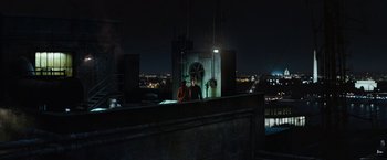 Movie still from “Mission: Impossible III” (2006), directed by J.J. Abrams – A man standing on top of a building at night; Extreme Wide shot, High angle