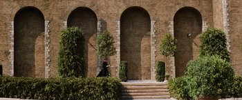 Movie still from “Mission: Impossible III” (2006), directed by J.J. Abrams – A man in a black suit is walking down the steps; Extreme Wide shot, Low angle