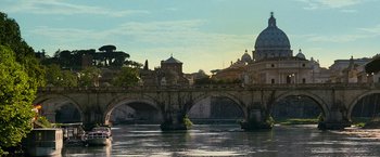 Movie still from “Mission: Impossible III” (2006), directed by J.J. Abrams – A view of a bridge and a church from across a river; Extreme Wide shot, Low angle