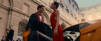 Movie still from “Mission: Impossible III” (2006), directed by J.J. Abrams – A man and a woman standing next to each other in front of a car; Medium shot, Low angle