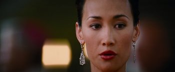 Movie still from “Mission: Impossible III” (2006), directed by J.J. Abrams – A person wearing a pair of earrings; Close Up shot, Over the shoulder angle