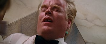 Movie still from “Mission: Impossible III” (2006), directed by J.J. Abrams – A person wearing a suit and tie; Close Up shot, Overhead angle